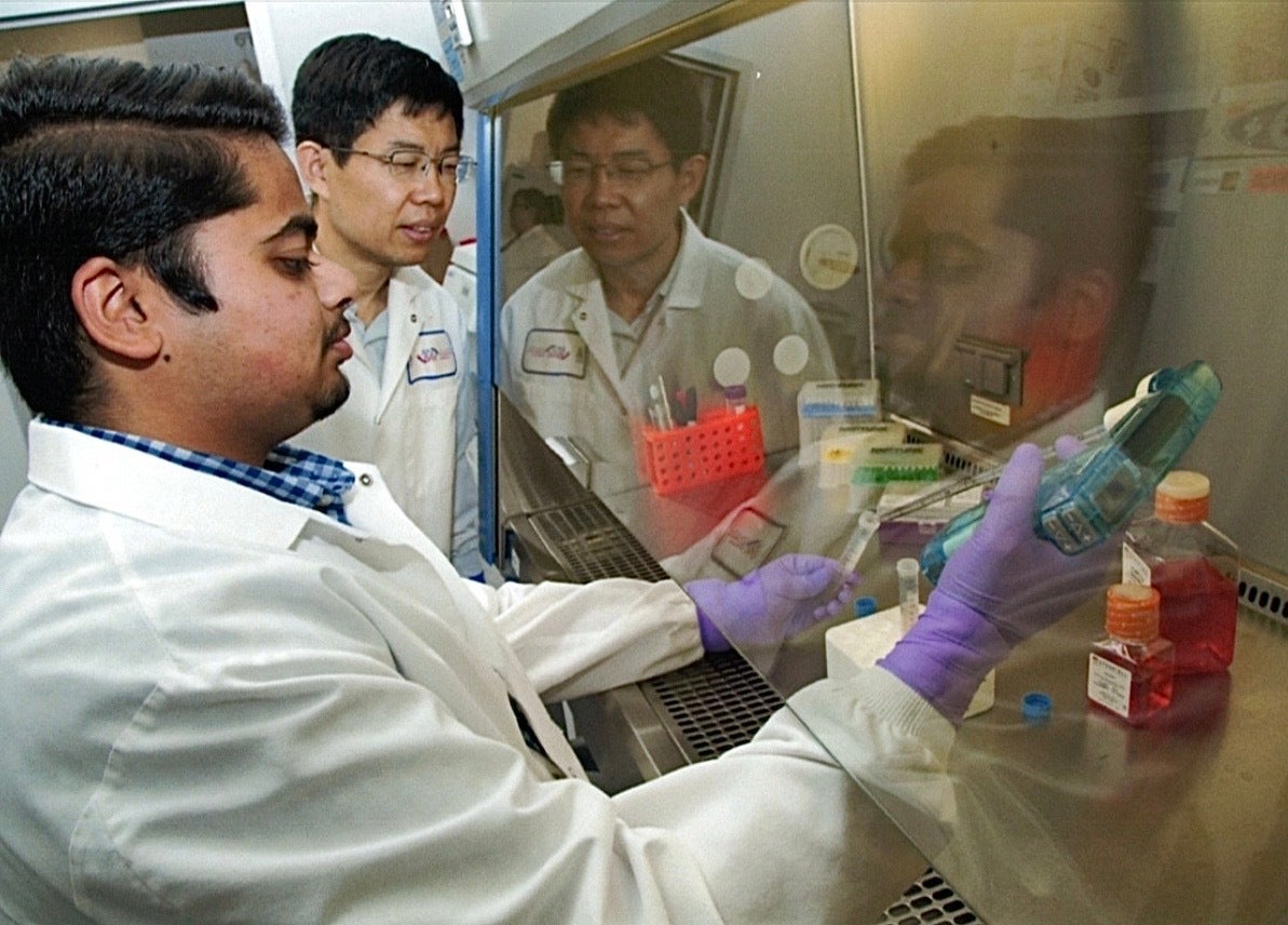 Nabhan Fakrudin with Dr. Jian Gu working in a lab