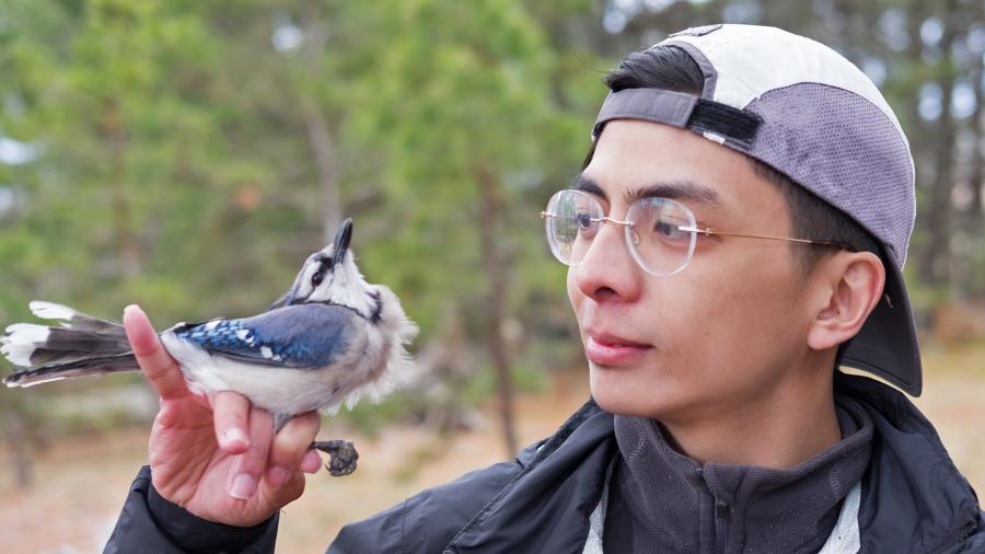 Jason Lacson holding a blue bird