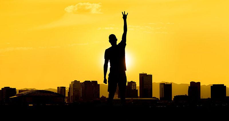 student with gold background